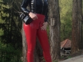 sexy latex model at czech fetish action wearing red latex jeggings + latex jacket with hood
