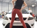 fetish model in red latex pants on public action called international prague car festival