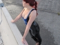 redhead on public construction site wearing rubber tight leggings and latex top plus high heels